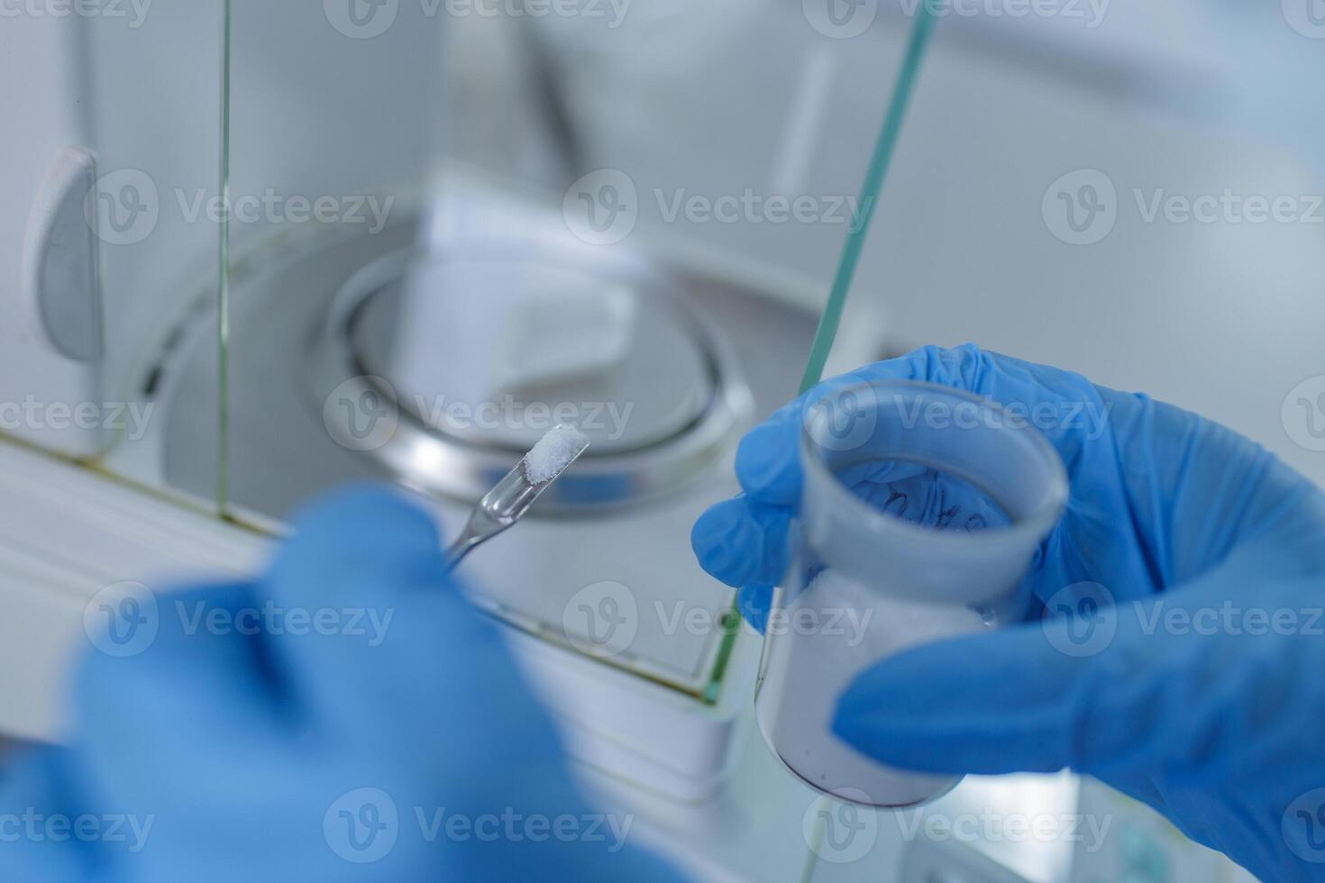 Lab Technician Weighing Chemical Powder on Precision Balance for Scientific Research and Pharmaceutical Analysis photo