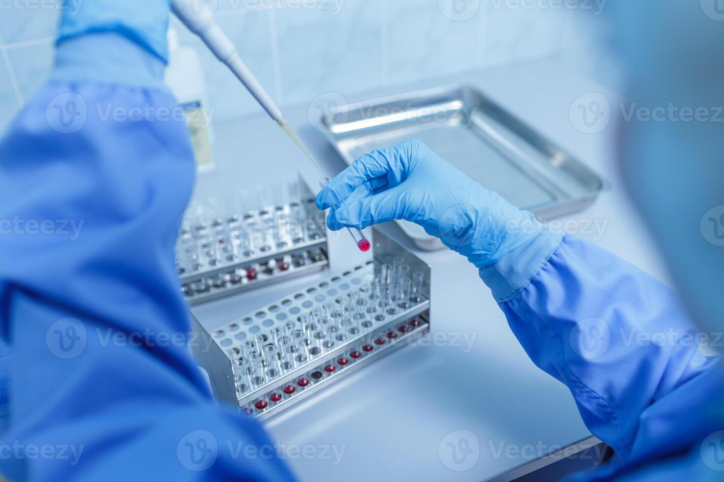 Lab Technician Using Pipette to Analyze Samples in Test Tubes for Medical Diagnostics and Scientific Research photo