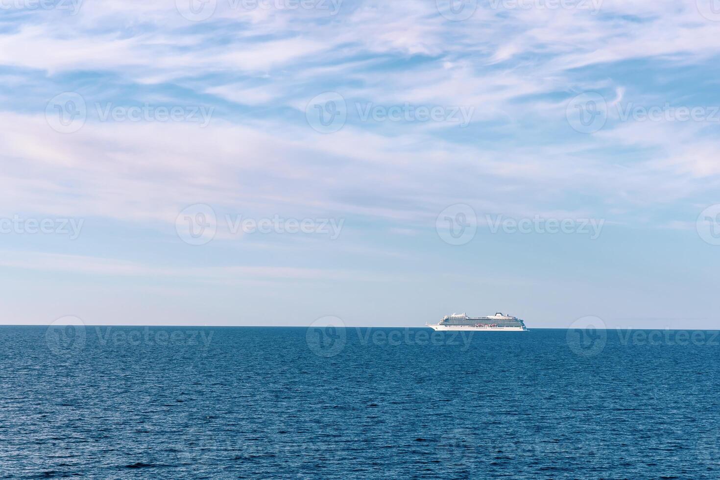 Seascape with a white ferry in the distance and waves. photo