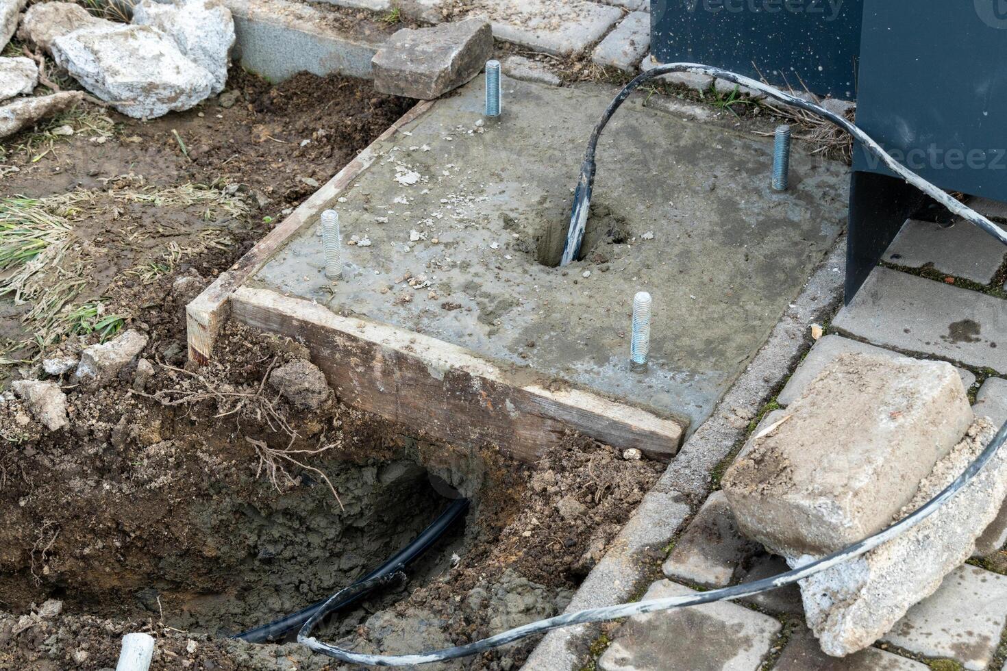 Preparing Concrete Foundation for a Structure with Embedded Cables and Anchor Bolts photo