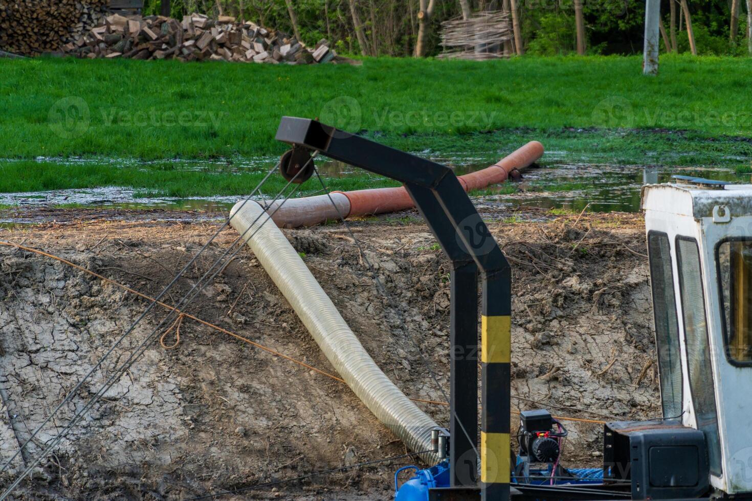 Heavy Industrial Pumping System with Large Hoses on Muddy Construction Site photo