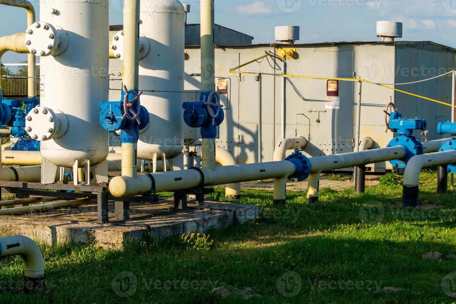 Pipeline System with Valves and Tanks at Industrial Processing Plant in Sunlight photo