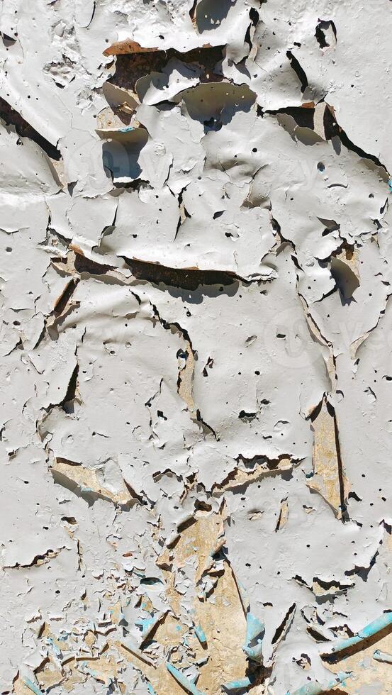 CloseUp Image Capturing Flaking Paint on the Wall Surface with Rich Texture and Detail photo
