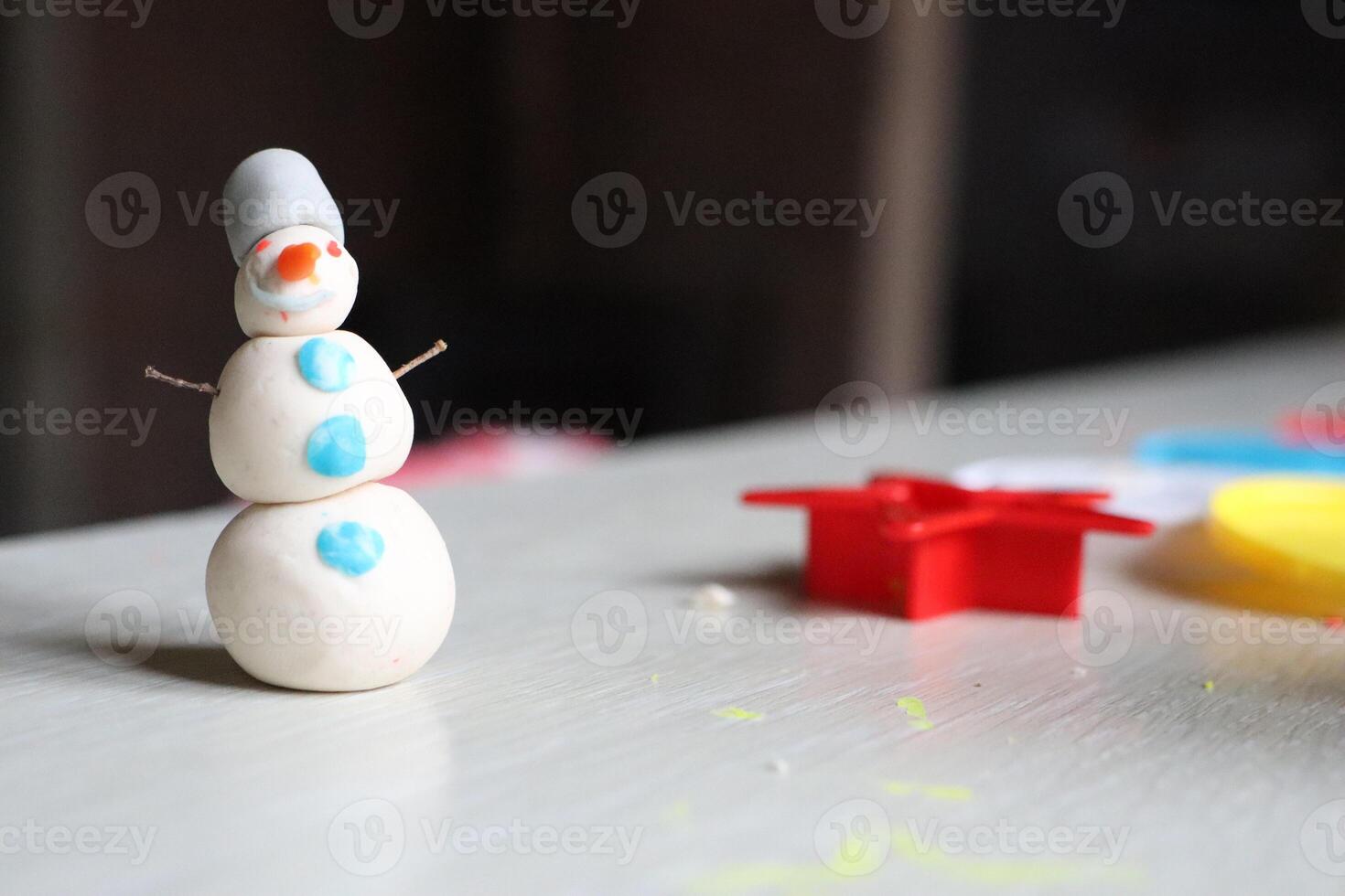 Adorable Handmade Snowman Figurine on a Craft Table Perfect for This Winter Season photo