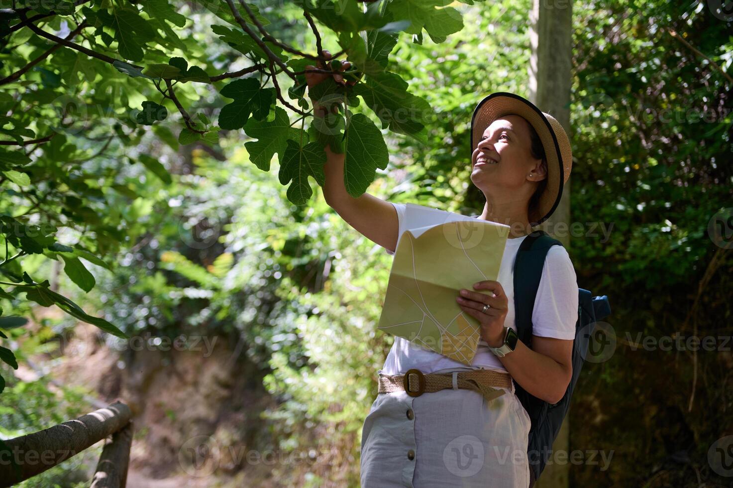 Woman Enjoying Outdoor Adventure in Natural Woodland Area While Exploring with a Map photo