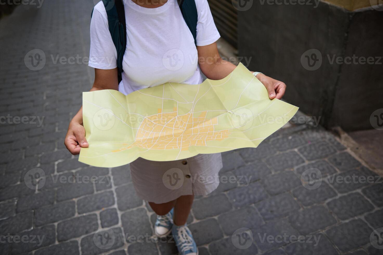 Woman Exploring a Quaint Old Town with a Map in Hand photo