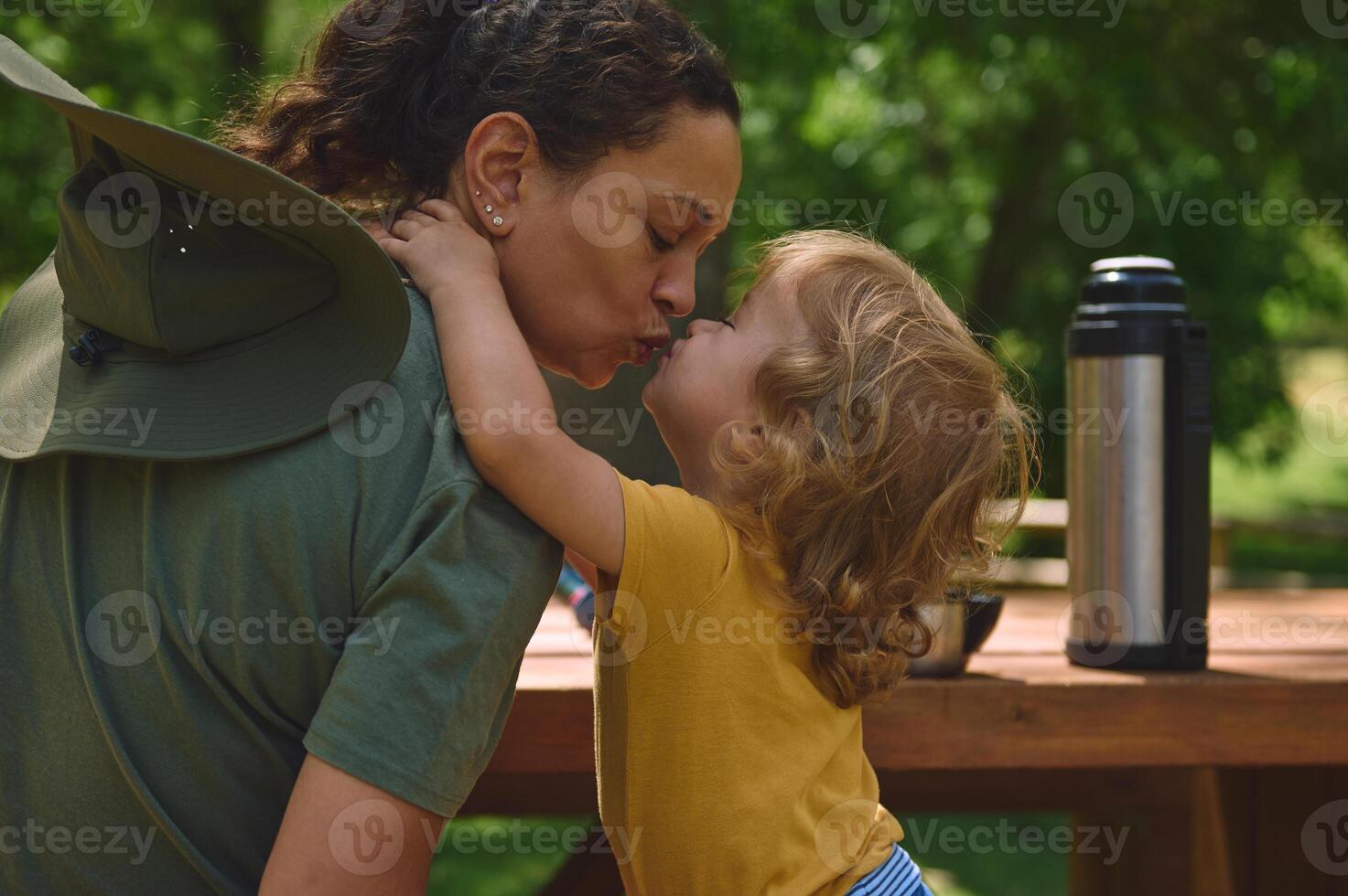 Mother and Child Sharing a Sweet Moment Outdoors in a Park photo