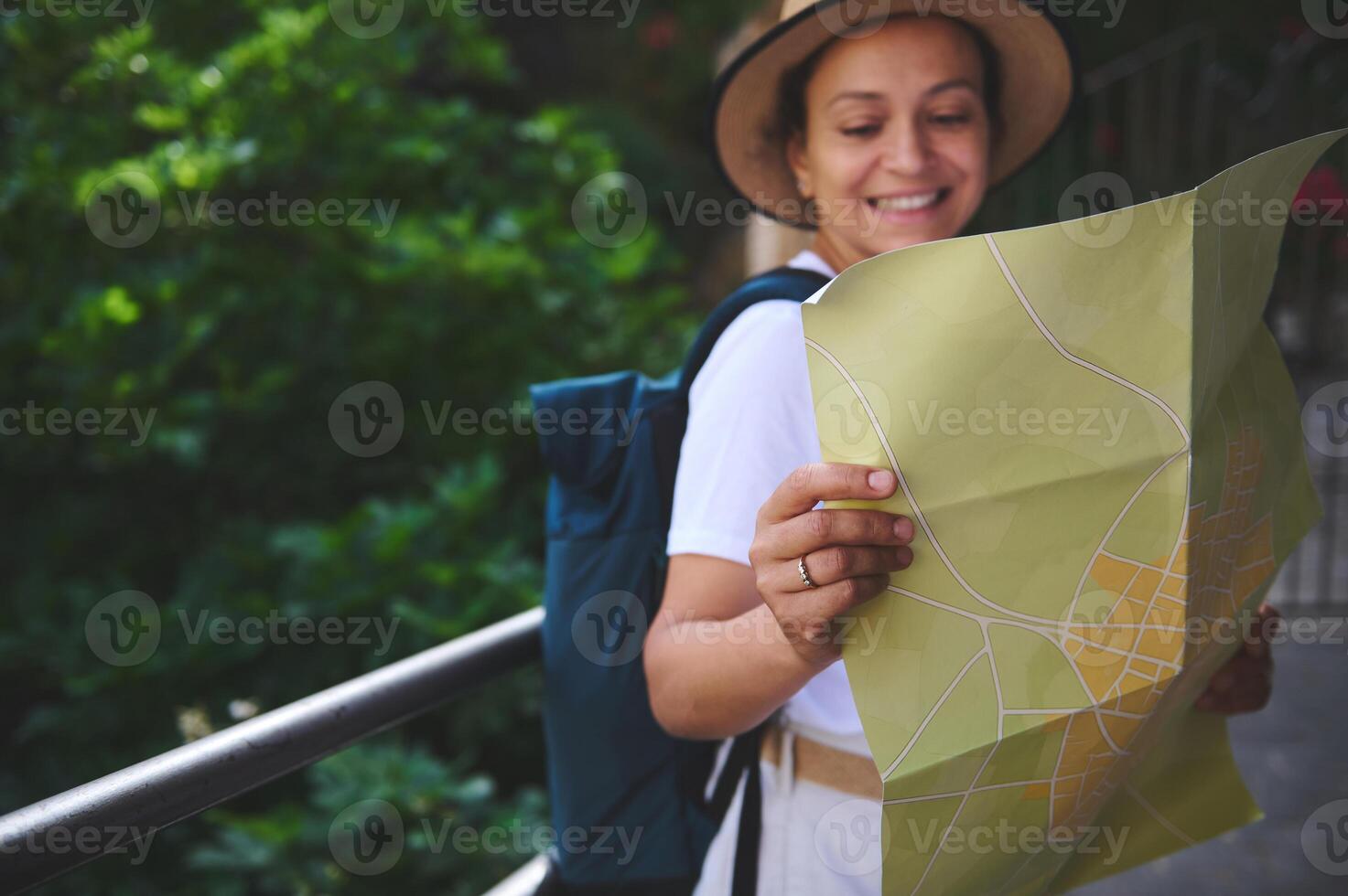 Woman Enjoying Exploration of a Scenic City While Using a Map to Navigate photo