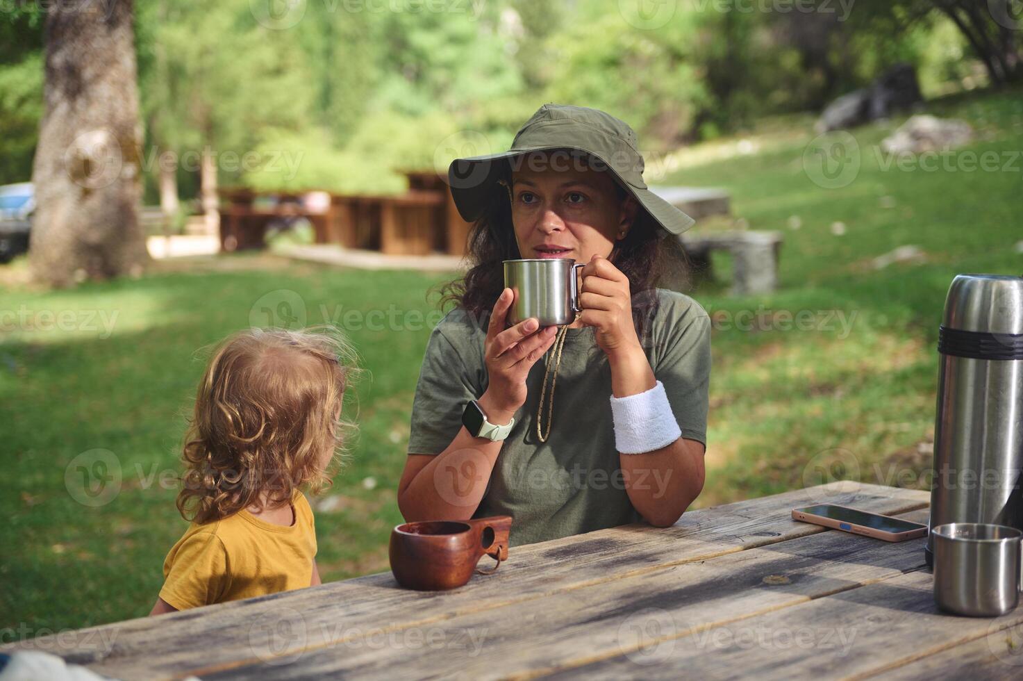 Mother and Child Enjoying a Relaxing Outdoor Moment on a Sunny Day photo