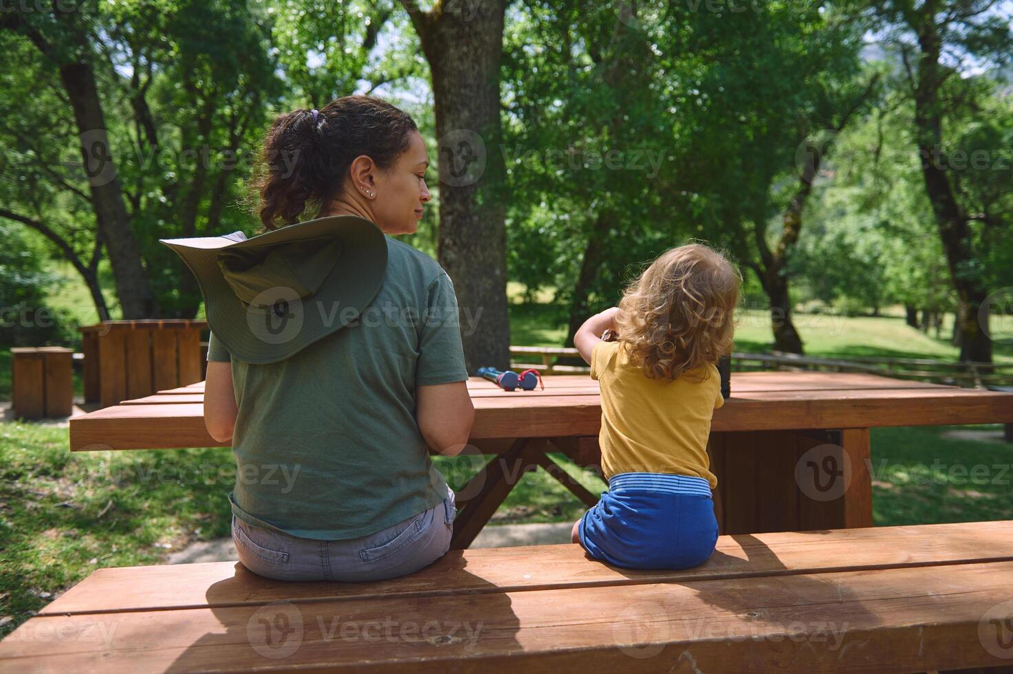Mother and Child Enjoy a Tranquil Moment Outdoors on a Sunny Day photo