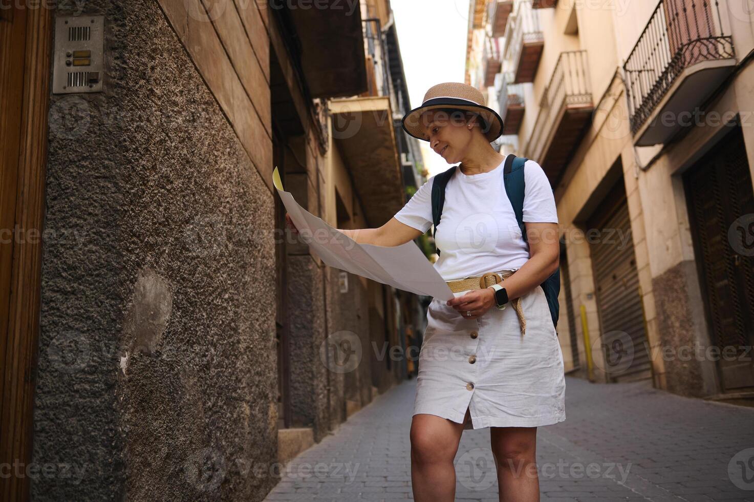 Female Tourist Exploring Historic Streets with a Map on a Journey photo