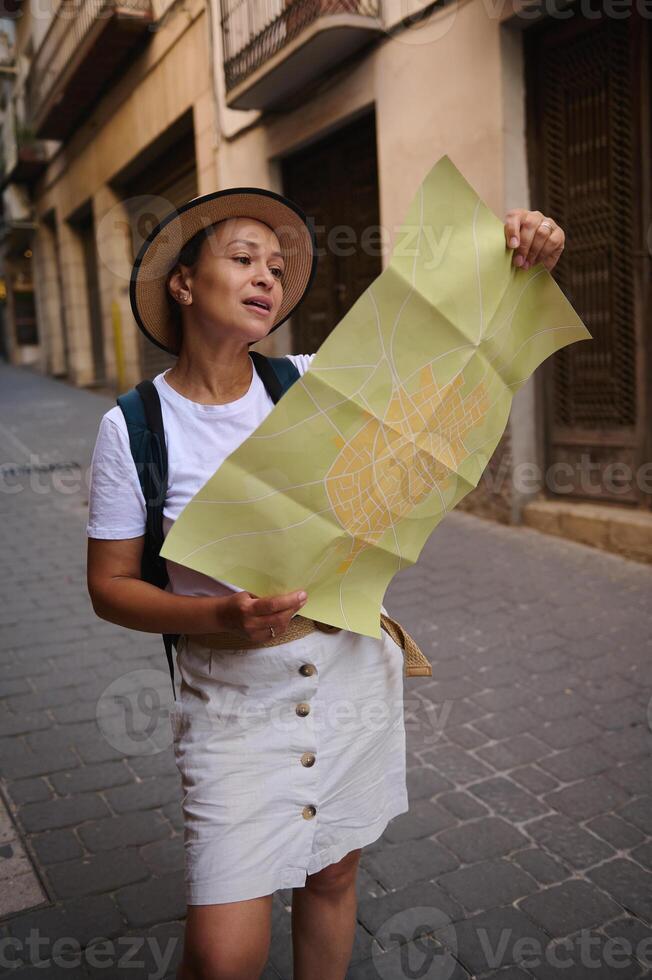 Woman Exploring Picturesque Streets With a Map in Hand photo