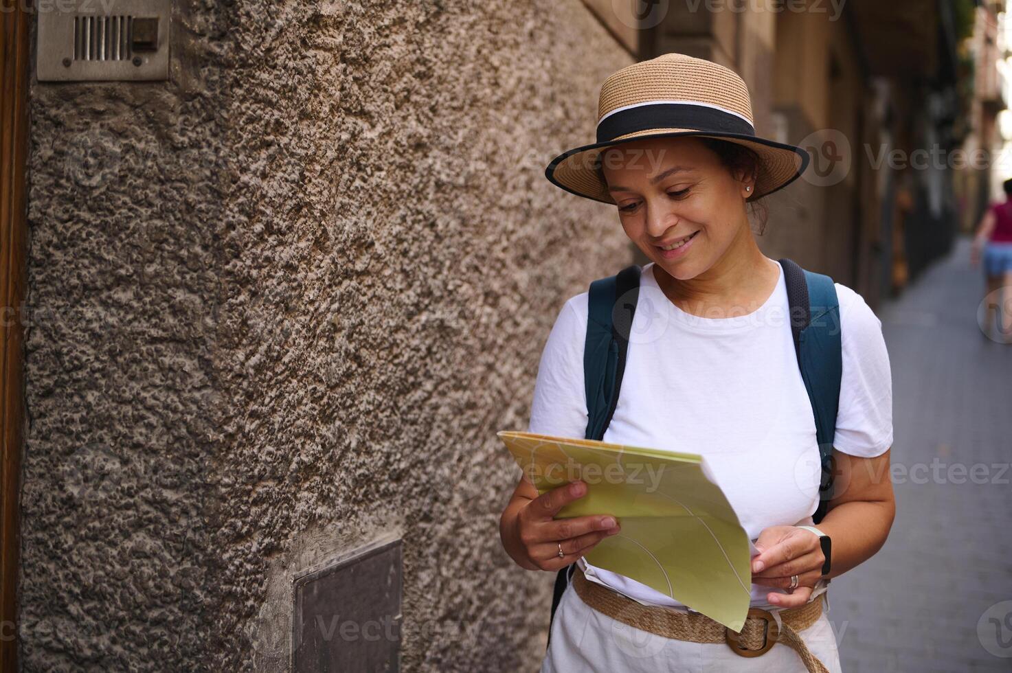 Smiling Woman Tourist Exploring a Historic City Holding a Paper Map photo
