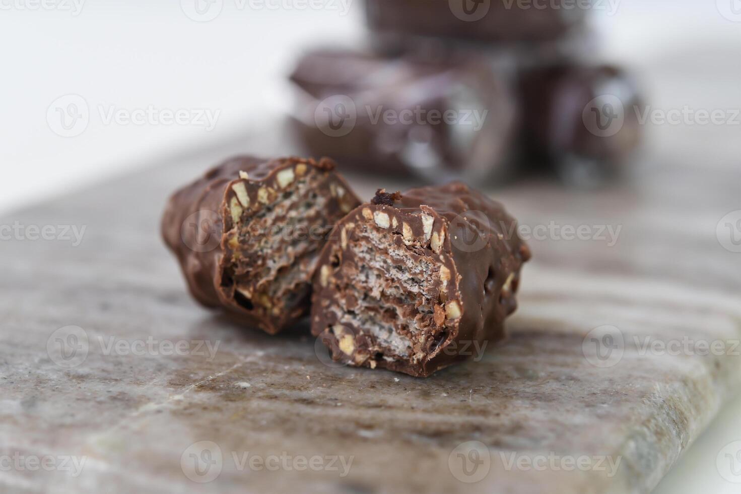 Chocolate Wafer Clusters on Marble, one broken open to reveal the crisp, closeup side view of sweet snack photo
