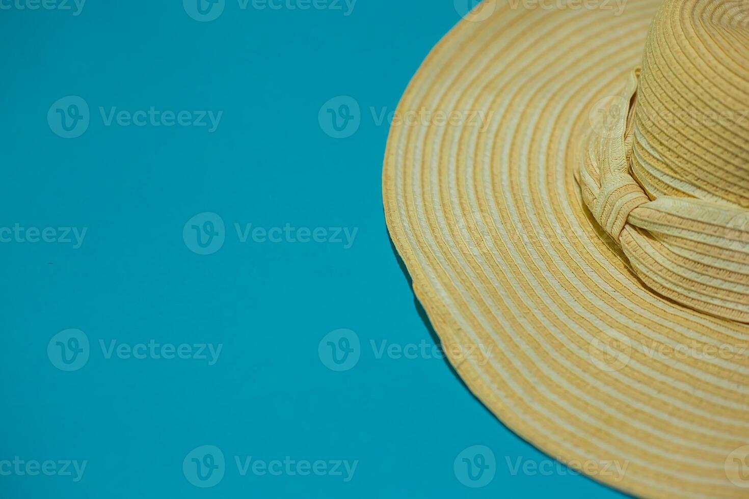 Hat with bow on a blue background. Summer concept. Background for layouts and advertising. photo
