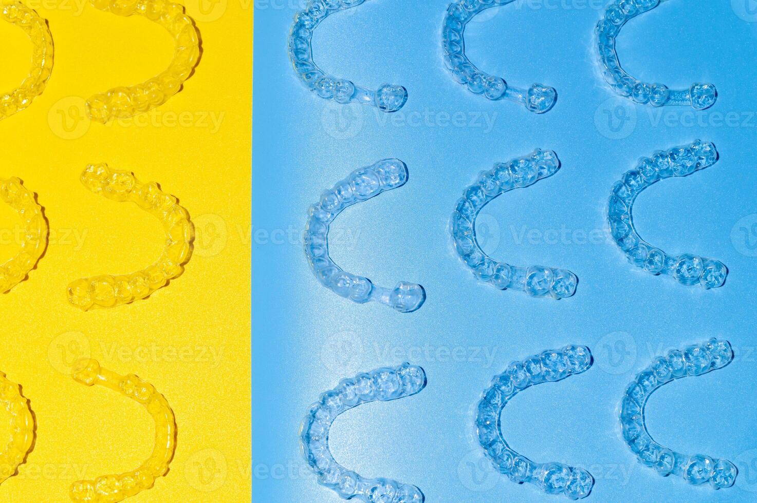 Invisible transparent brackets or parentheses on blue yellow background lie in a pattern, top view photo