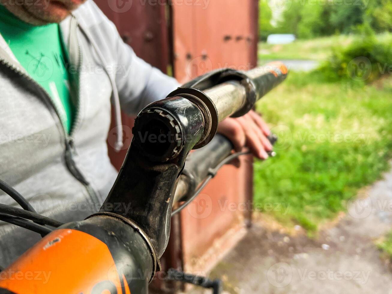 Mechanic fixing broken bicycle stem in workshop photo