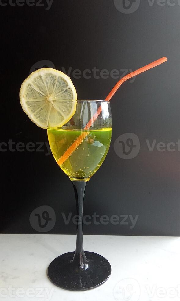 isolated cosmopolitan on a black background garnished with a lemon photo