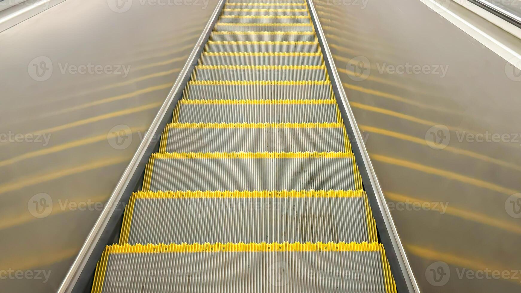 Empty Yellow-Lined Escalator Steps in Urban Subway Station photo