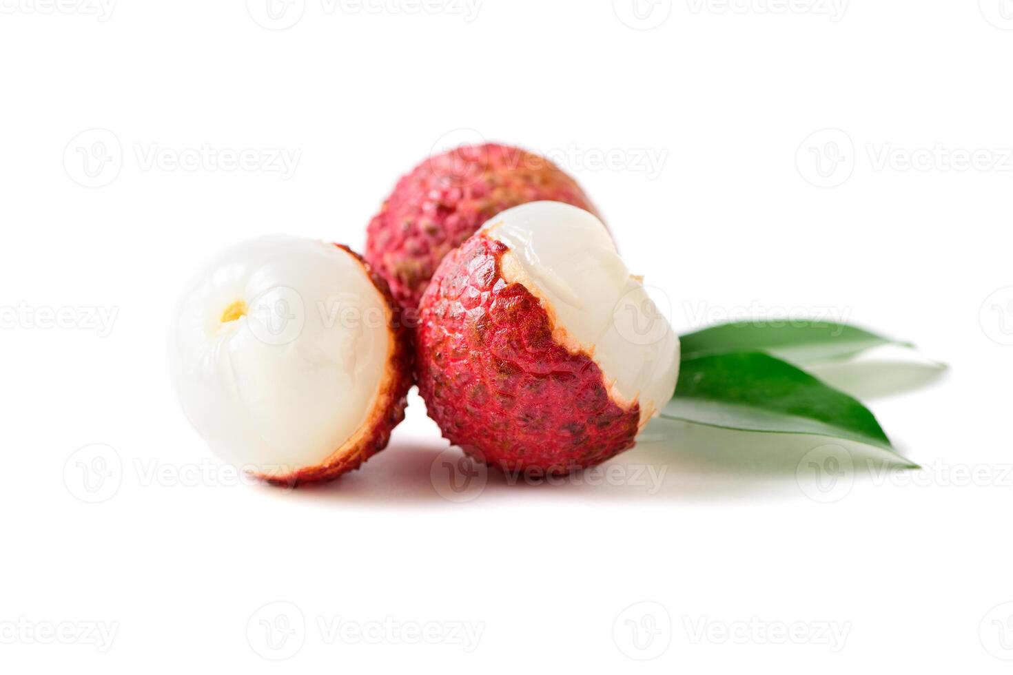 Three Juicy Lychee with cut in half and leaves isolated photo