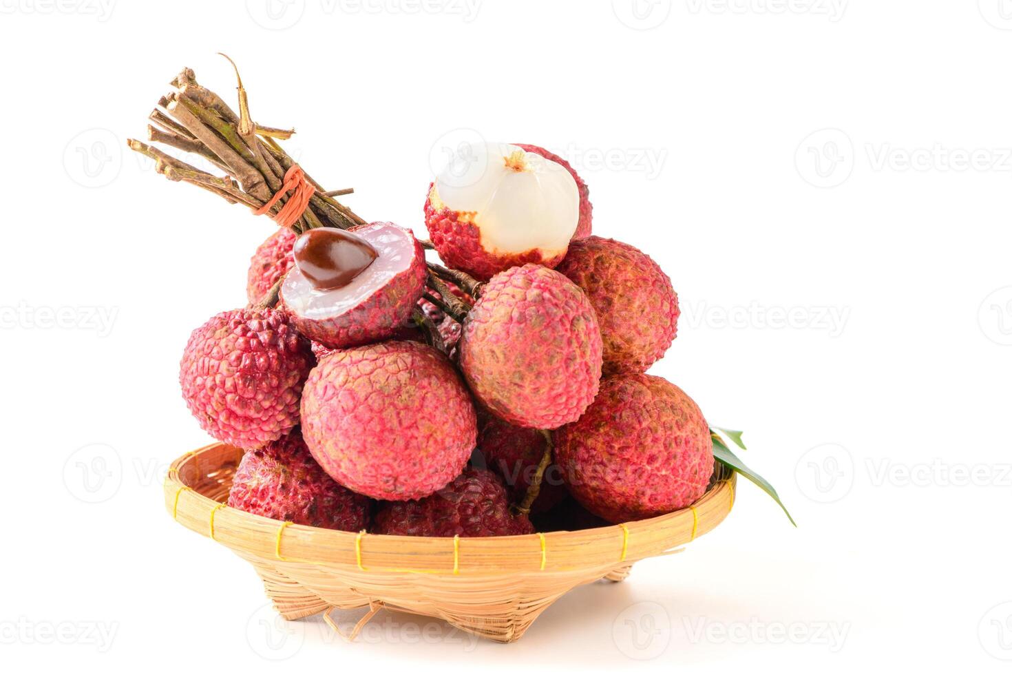 Juicy Lychee with cut in half and leaves on bamboo basket isolated on white background. Thai fruits. photo