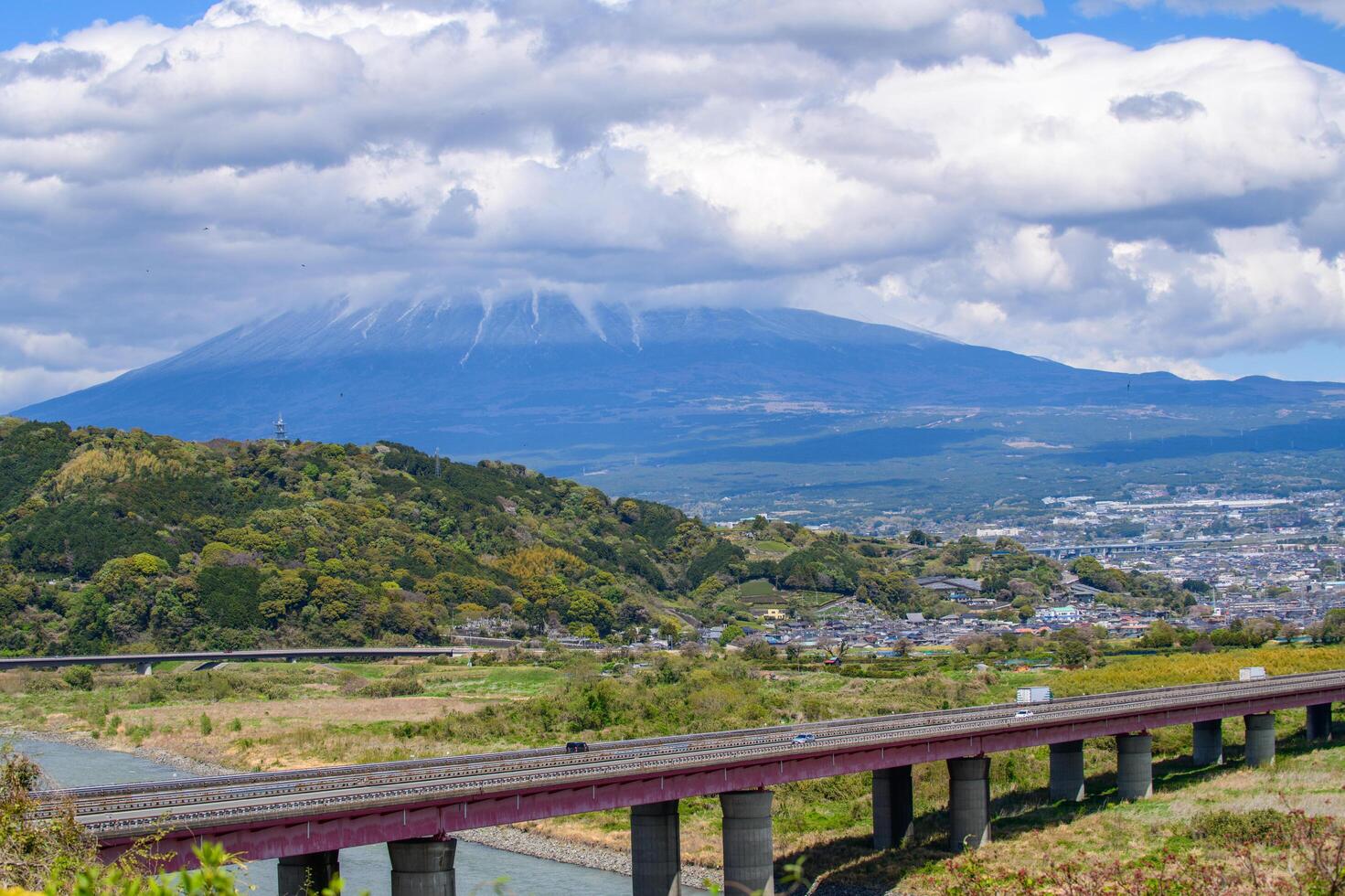 This panoramic landscape captures the peaceful coexistence of urban life and nature in rural Japan. the iconic Mount Fuji rises majestically, Shizuoka Japan photo