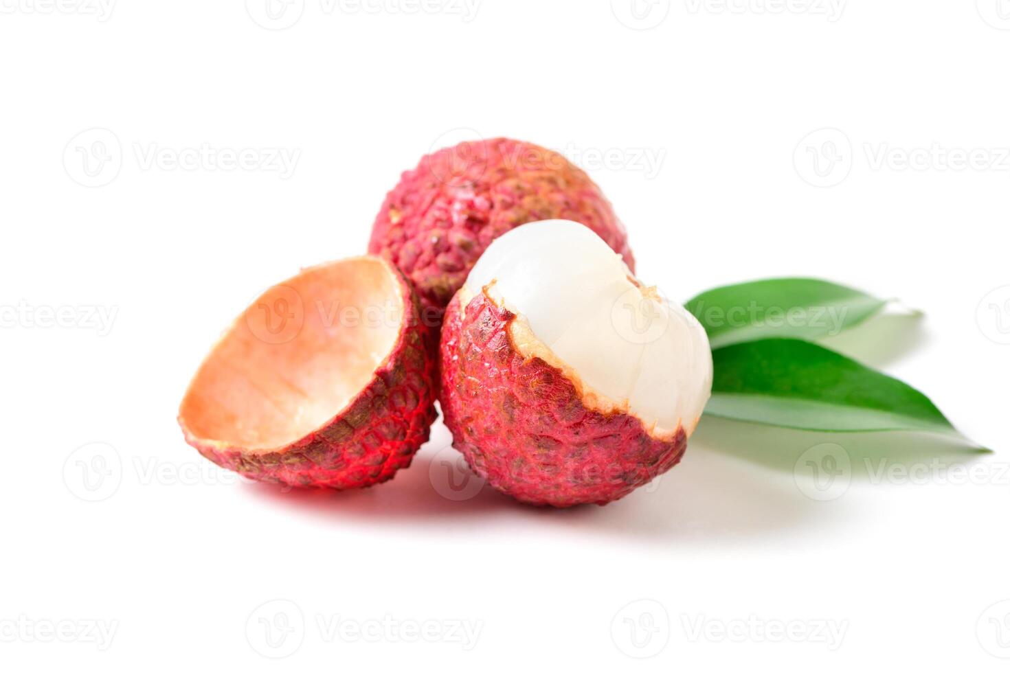 Three Juicy Lychee with cut in half and leaves isolated. photo