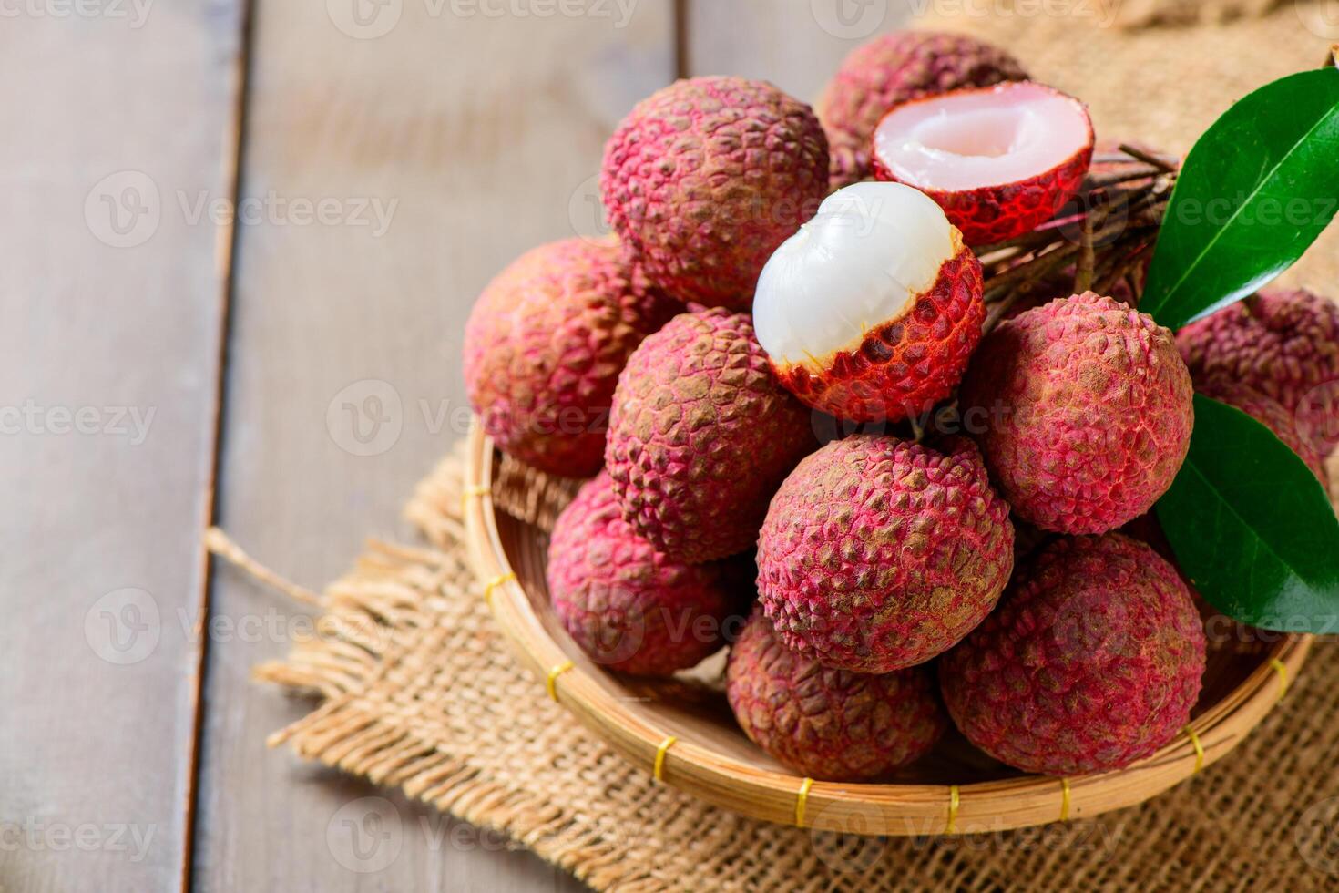 tyop view of Juicy Fresh Lychee in Bamboo Basket on Rustic Wooden Table Tropical Exotic Fruit photo
