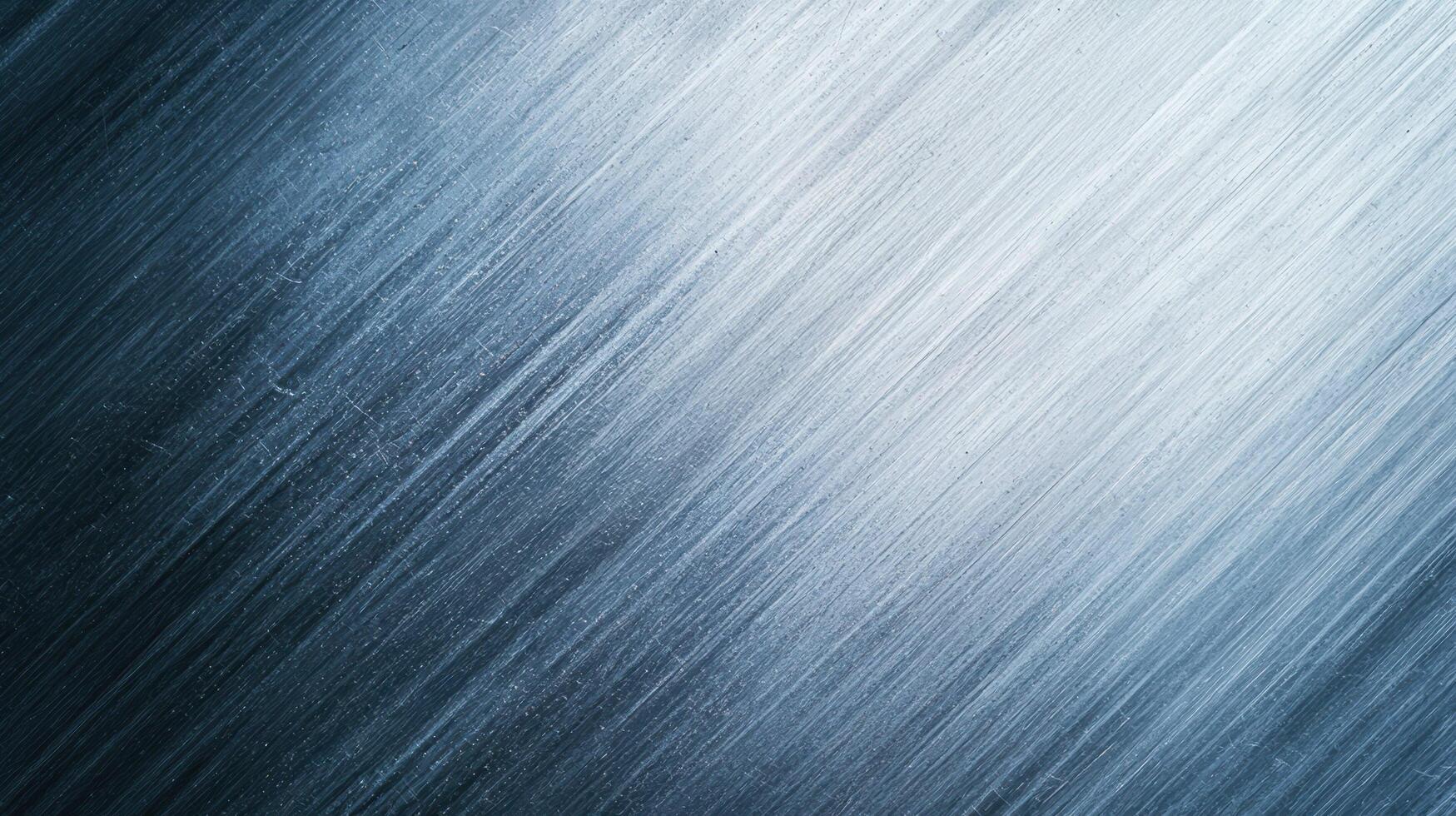 Brushed steel texture with diagonal lighting and fine linear patterns creating a modern industrial surface background. photo