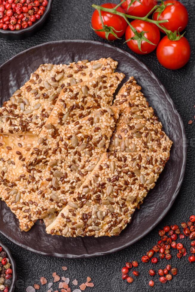 Crispbread, thin bread with seeds and grains, a baked cracker. photo