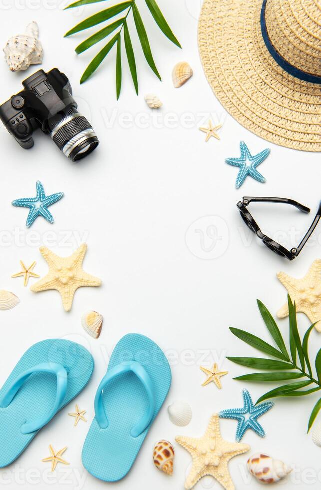 Summer accessories creating a frame on white background with copy space photo