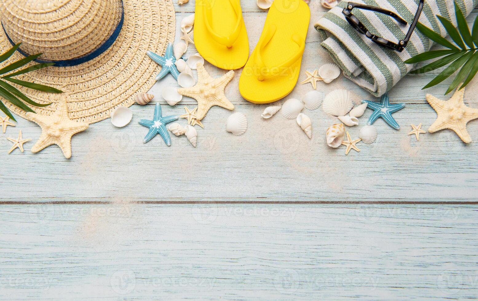 Summer accessories creating a frame on a wooden background with copy space photo