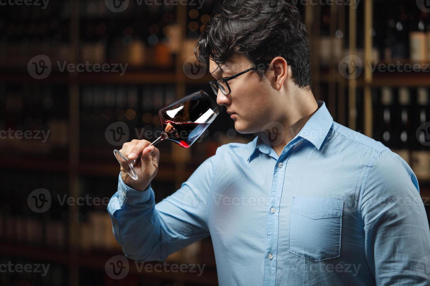 Professional Sommelier Evaluating Red Wine in Cellar Environment photo