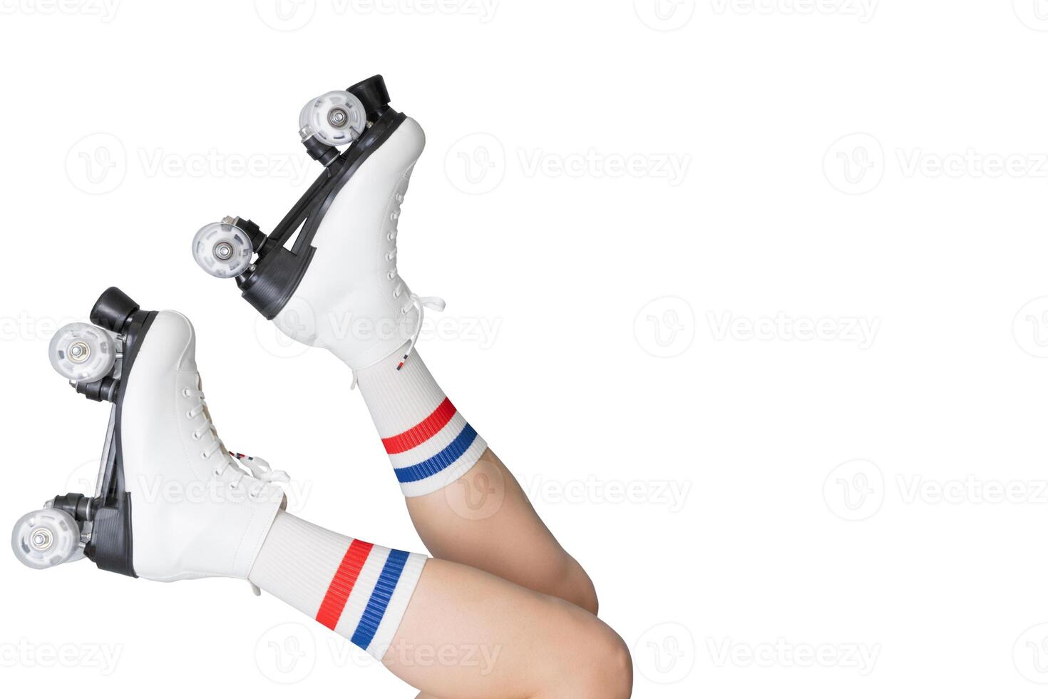 Female adult wearing retro roller skates with striped socks on white background photo