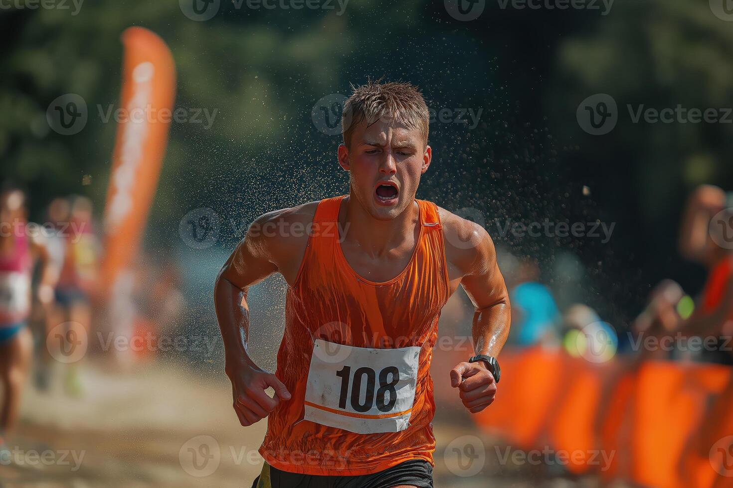Determined athlete running through water obstacle in obstacle course race photo
