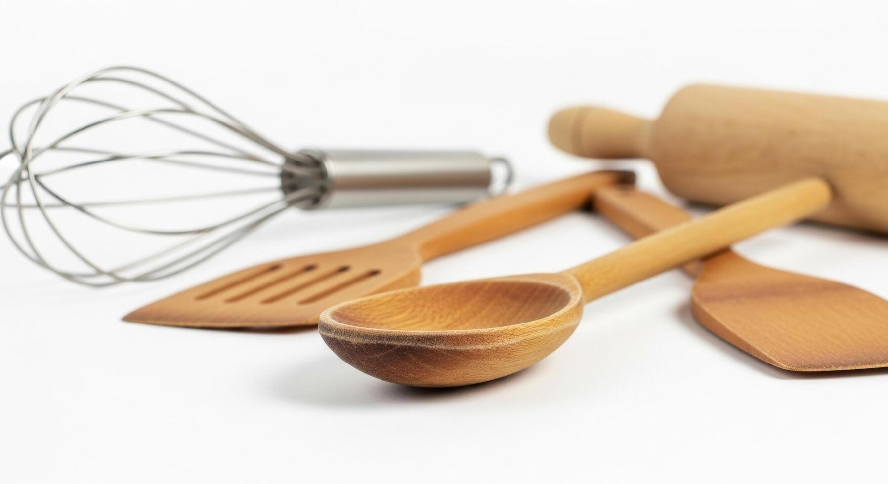 Wooden Cooking Utensils Spoon, Spatula, Rolling Pin, and Whisk on White Background photo