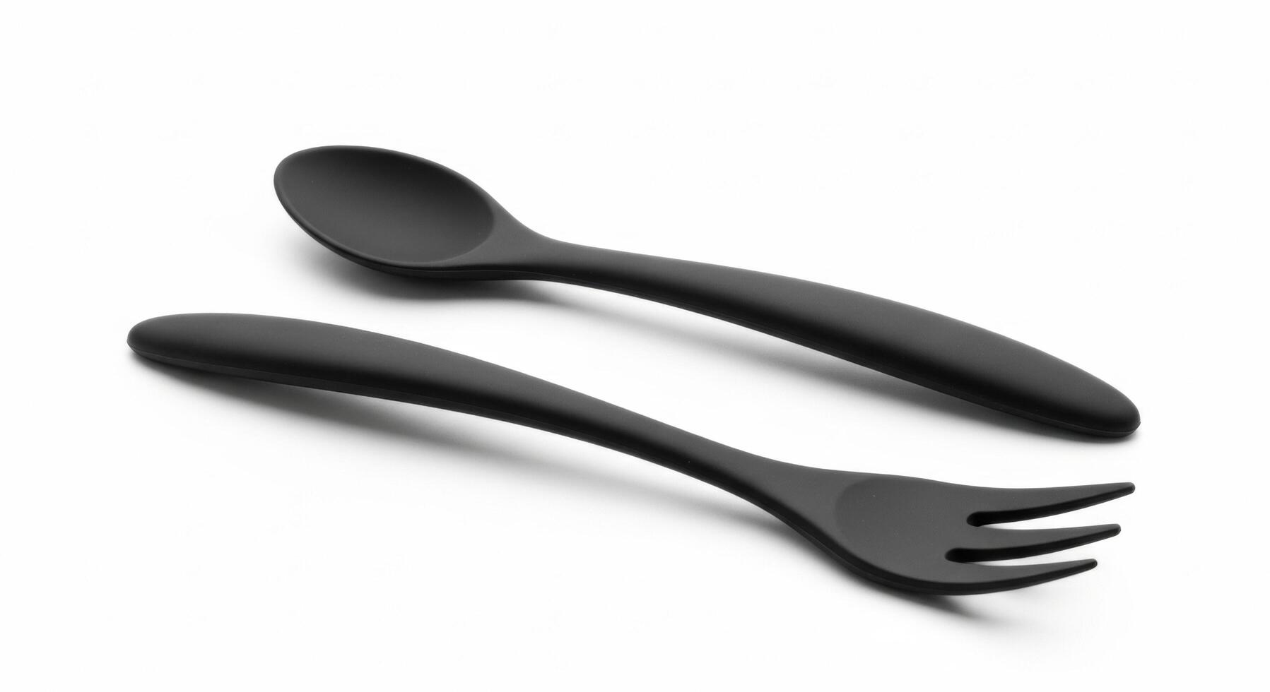Matte black fork and spoon set on a stark white background photo