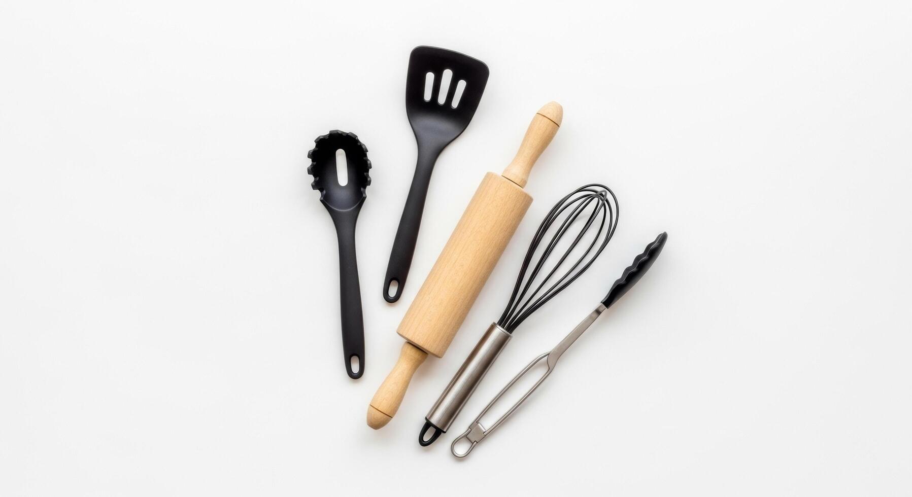 Kitchen Utensils Rolling Pin, Whisk, Spatula, and Tongs on White Background photo