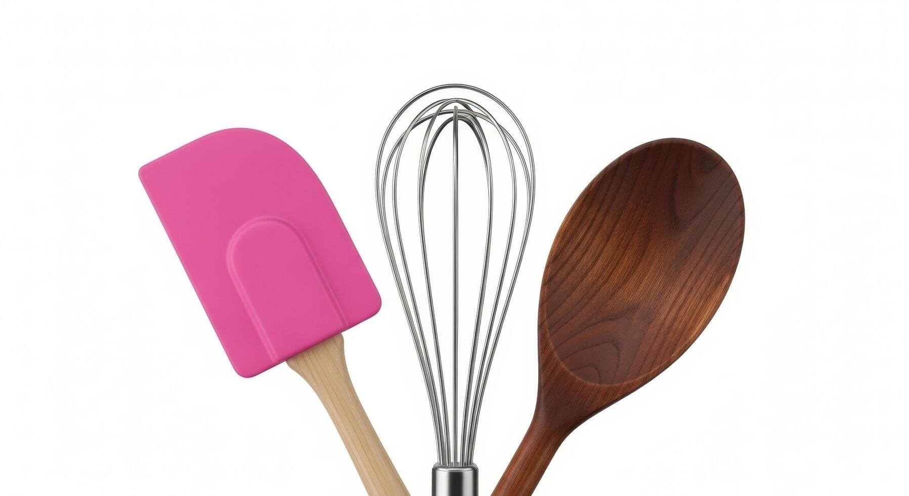 Pink Spatula, Wire Whisk, and Wooden Spoon on a Clean White Background photo