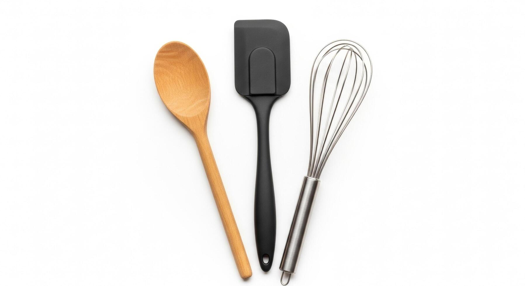 Kitchen Utensils Wooden Spoon, Black Spatula, and Stainless Steel Whisk on White photo
