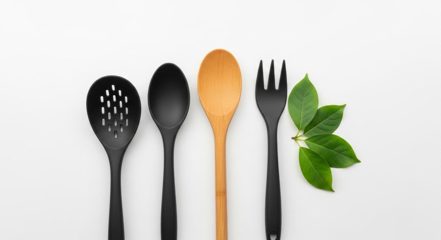 Kitchen Utensils with Green Leaves on White Background, Flat Lay photo