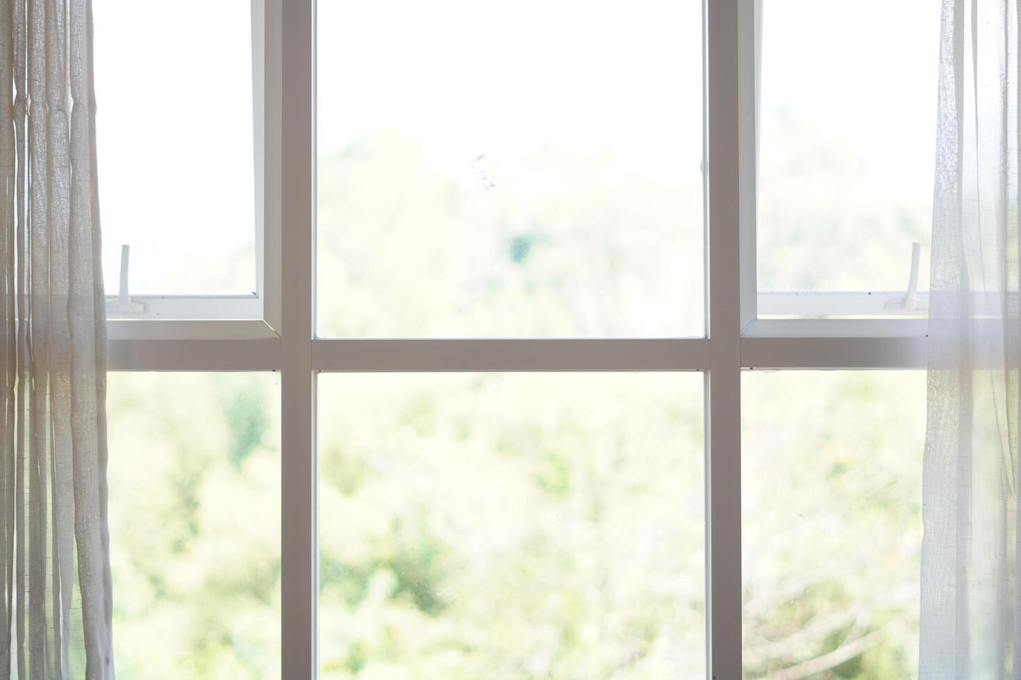Minimalist white box shaped window with curtains open during the day photo