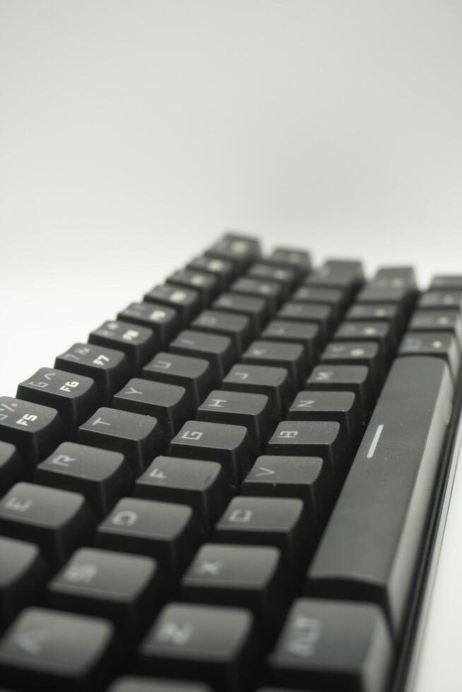 A mechanical keyboard with a 61 layout in black from the top with a white background photo