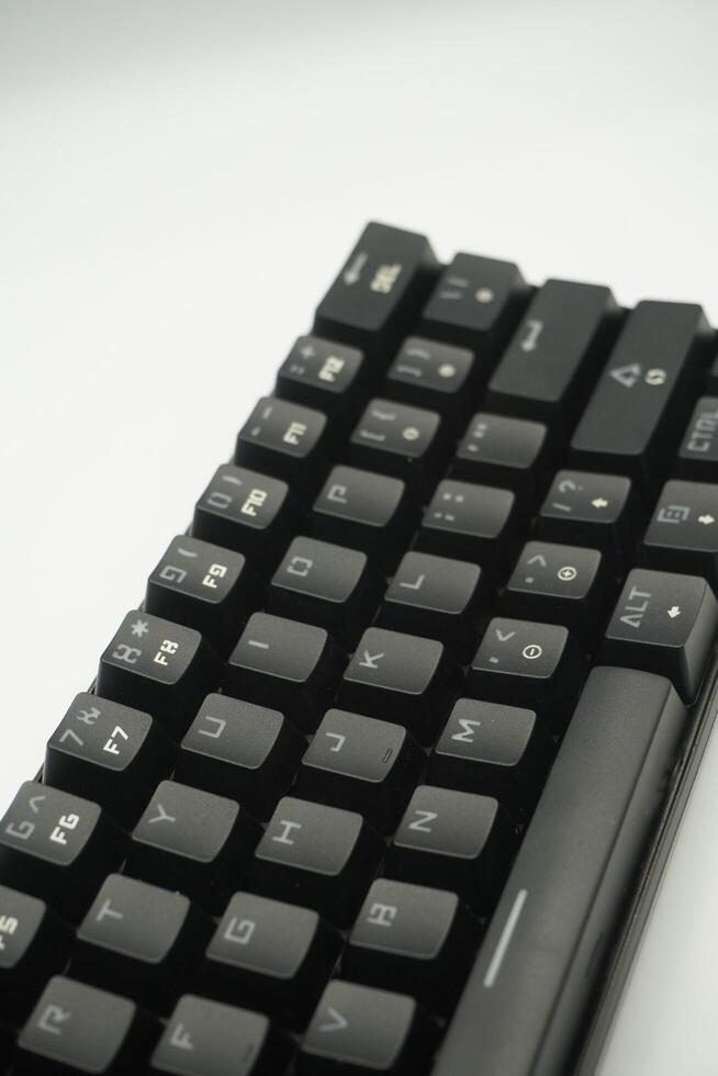 A mechanical keyboard with a 61 layout with black color and a white background photo