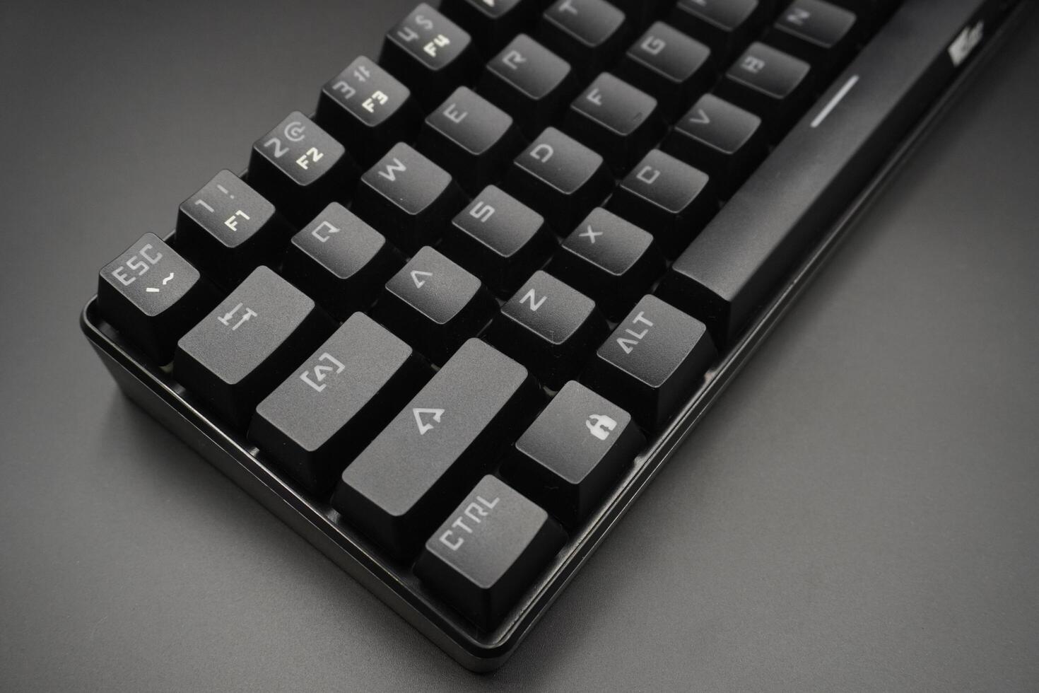 A black mechanical keyboard on a black background photo