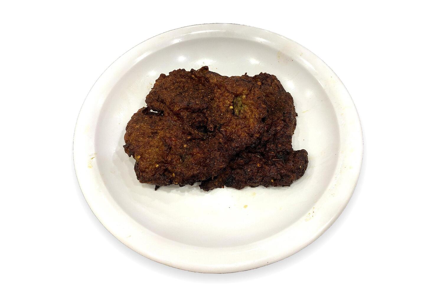Flavourful and juicy beef chappal kebab in a white plate beautifully isolated on the white background photo
