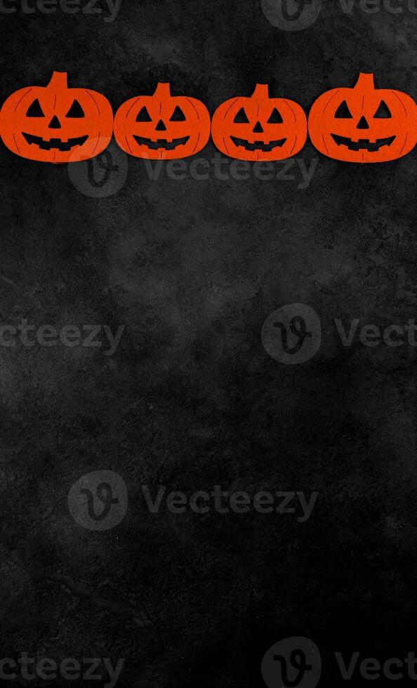Vertical banner with pumpkins against dark mystery concrete background. Halloween flat lay with place for text. Card or invitation for october 31. photo