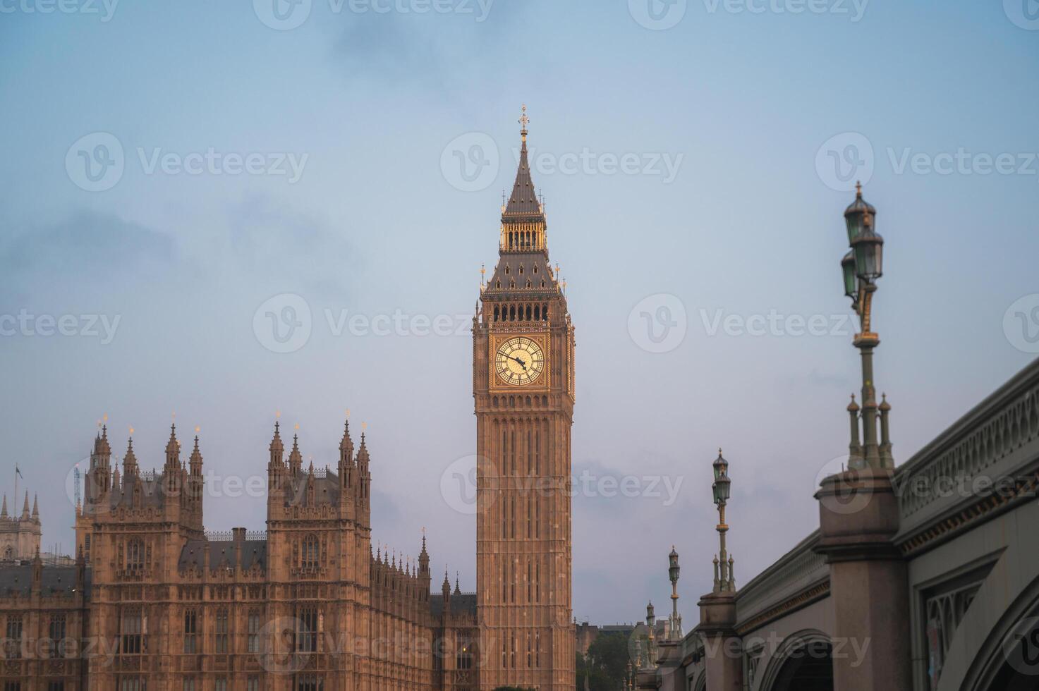 The Big Ben and Houses of Parliament against blue sky - London, UK.Tourist landmarks photo