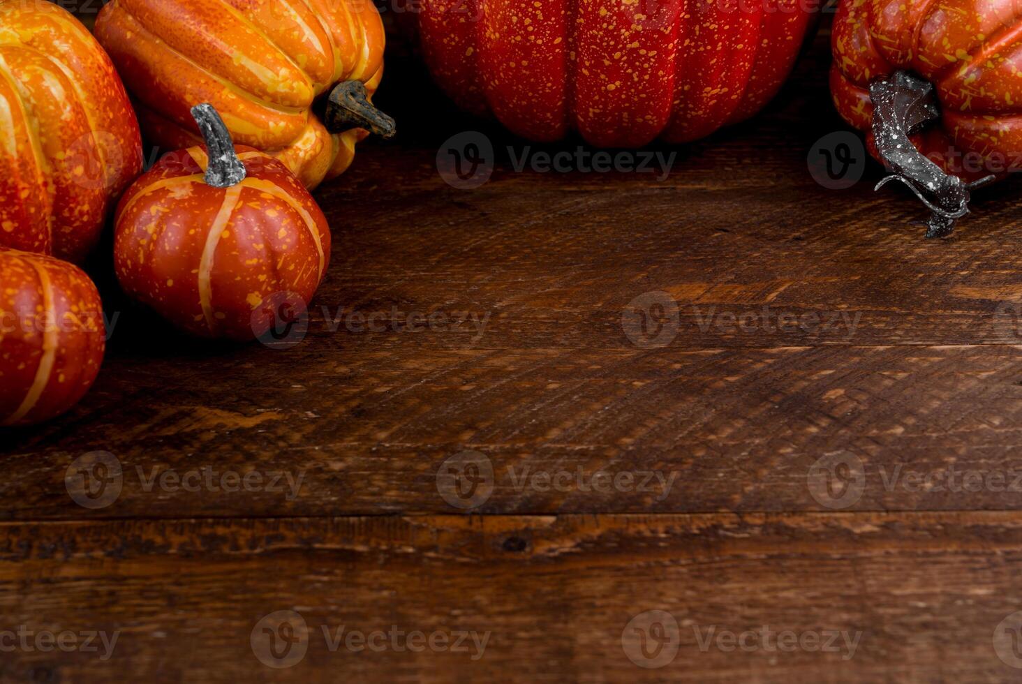 Thanksgiving flat lay with pumpkins on wooden background with place for text photo