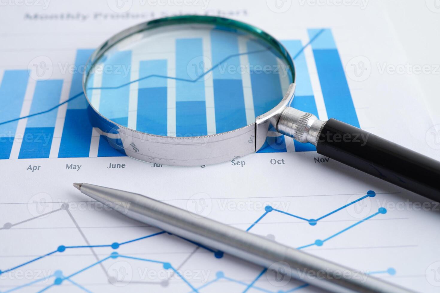 Magnifying glass on spreadsheet and graph paper. Financial development, Banking Account, Statistic, Investment Analytic research data economy, Business. photo